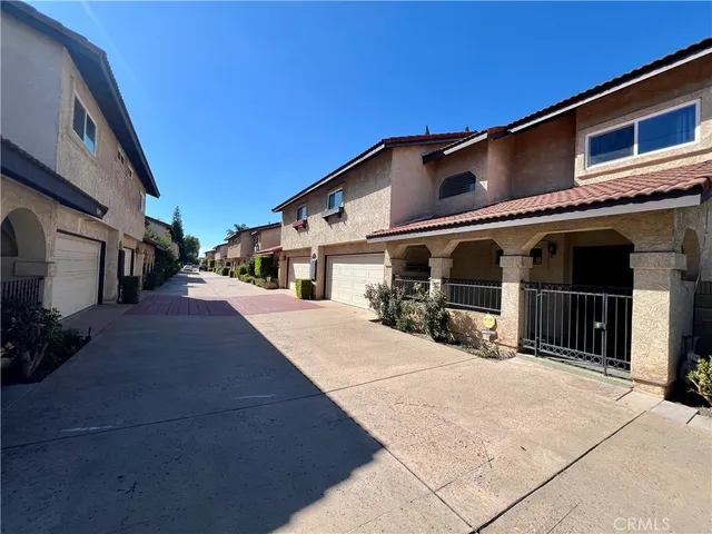 a front view of a building with parking area