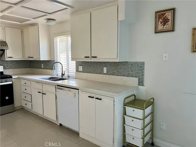 a kitchen with cabinets and window