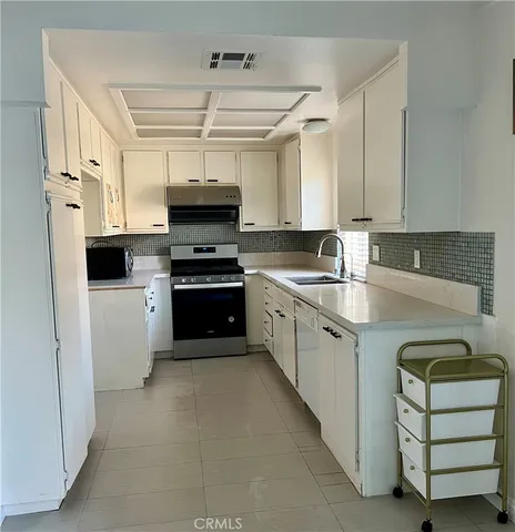 a kitchen with cabinets and white appliances