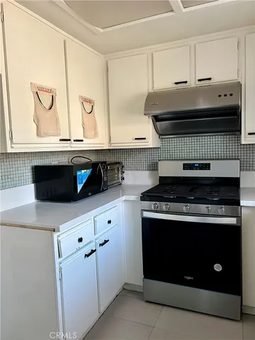 a kitchen with granite countertop a stove and a sink