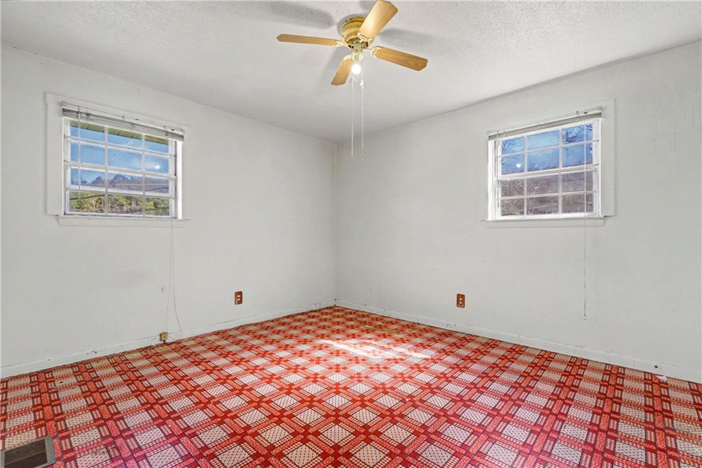 1408 Prospect Road Chickamauga, GA 30707 - Photo 11 of 27 a view of a big room with wooden floor and windows