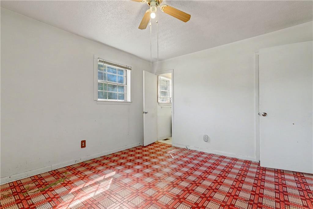 1408 Prospect Road Chickamauga, GA 30707 - Photo 12 of 27 a bedroom with a bed and a chandelier fan