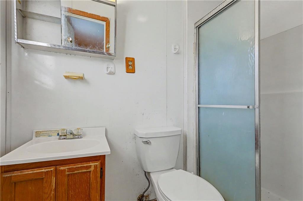 1408 Prospect Road Chickamauga, GA 30707 - Photo 14 of 27 a bathroom with a sink a toilet and mirror