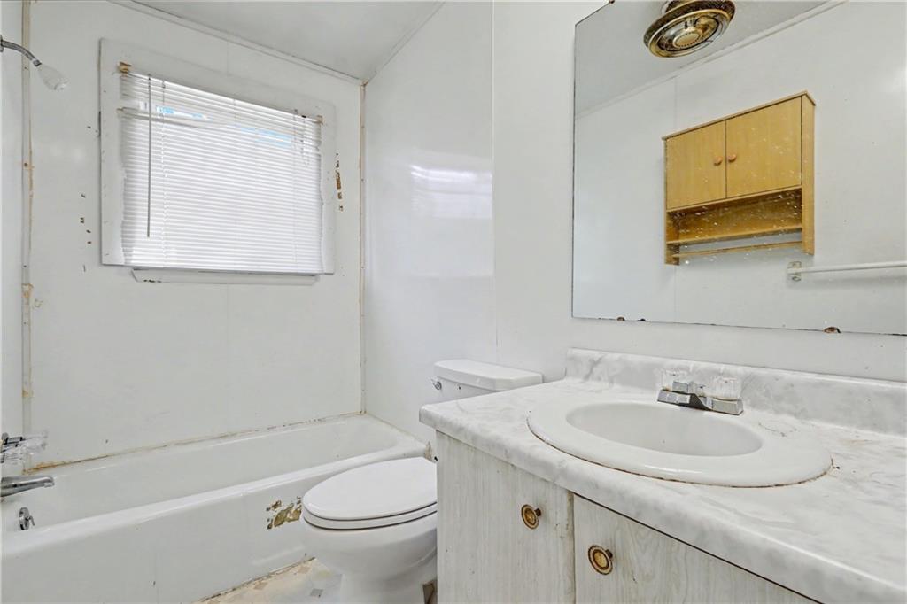 1408 Prospect Road Chickamauga, GA 30707 - Photo 21 of 27 a bathroom with a granite countertop sink toilet and a mirror