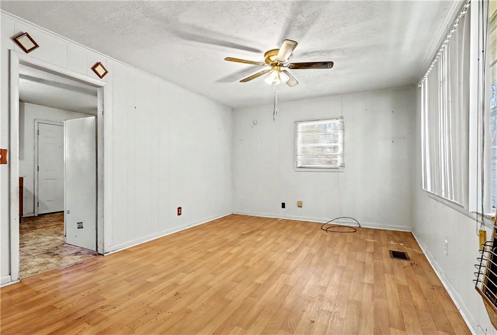 1408 Prospect Road Chickamauga, GA 30707 - Photo 3 of 27 a view of an empty room with wooden floor and a window