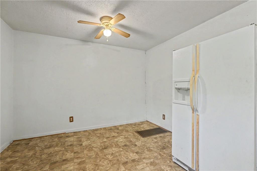 1408 Prospect Road Chickamauga, GA 30707 - Photo 9 of 27 an empty room with a window and a ceiling fan