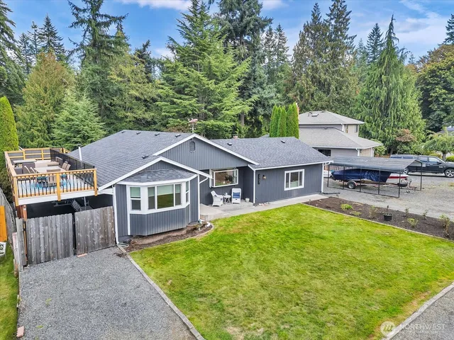 a aerial view of a house with swimming pool next to a yard