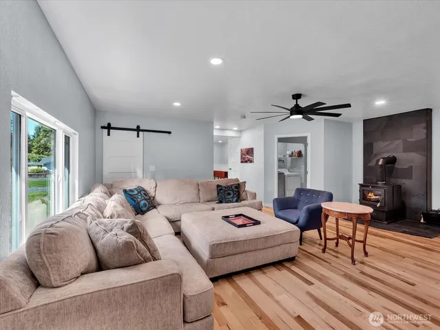 a living room with furniture and a ceiling fan