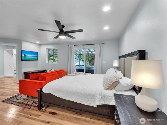 a bedroom with a large bed and a large window