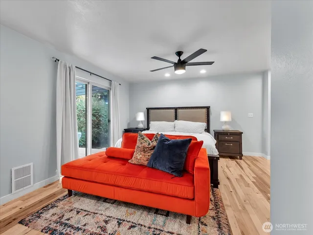 a bathroom with a toilet a sink a mirror and a faucet