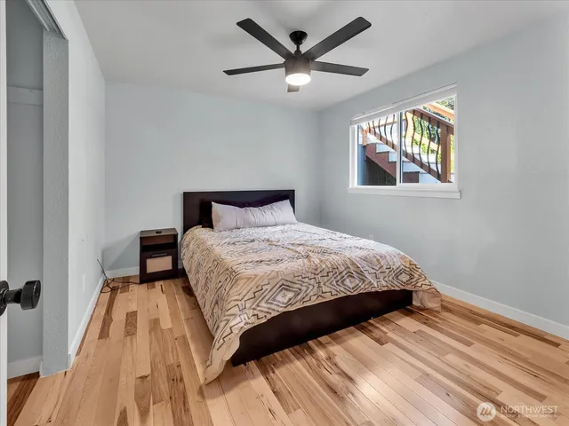 a bed sitting in a bedroom next to a window
