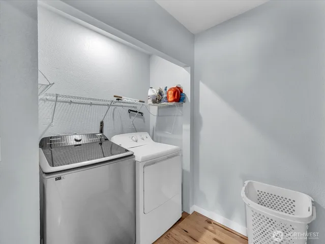a view of a backyard with barn fence and large trees