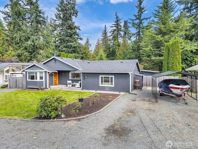 a view of a backyard with table and chairs with wooden fence