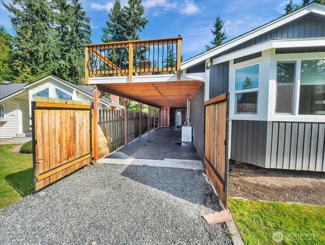a view of a house with backyard porch and wooden fence