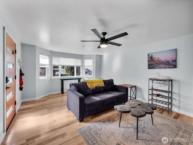 a living room with furniture and wooden floor