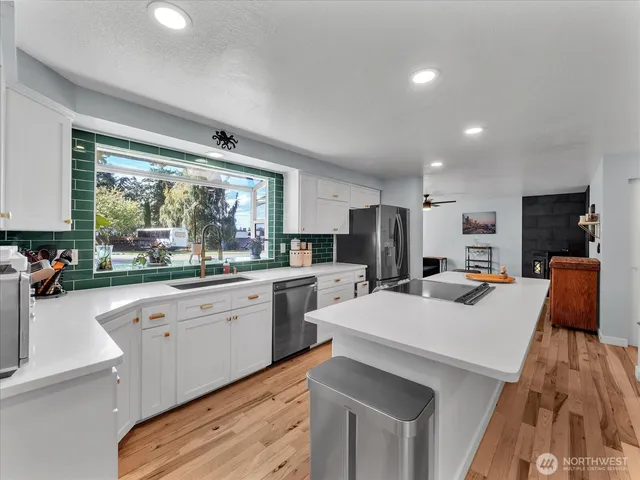 a large white kitchen with a large window