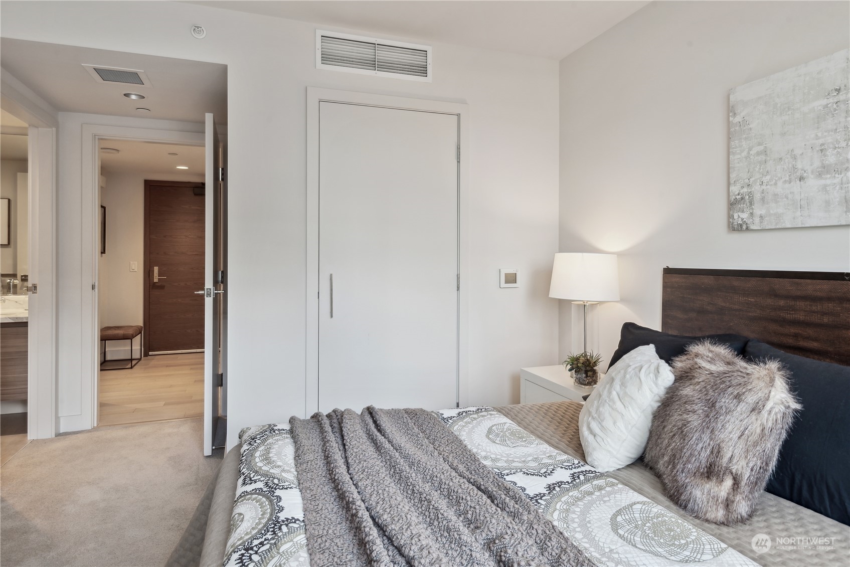 583 Battery Street, Unit 506N Seattle, WA 98121 - Photo 13 of 36 a bed room with a bed and a lamp