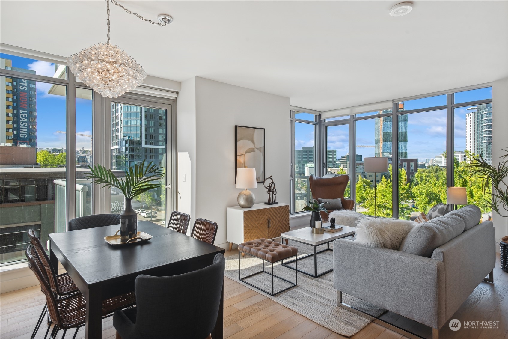 583 Battery Street, Unit 506N Seattle, WA 98121 - Photo 2 of 36 a living room with furniture a chandelier a large window and a chandelier