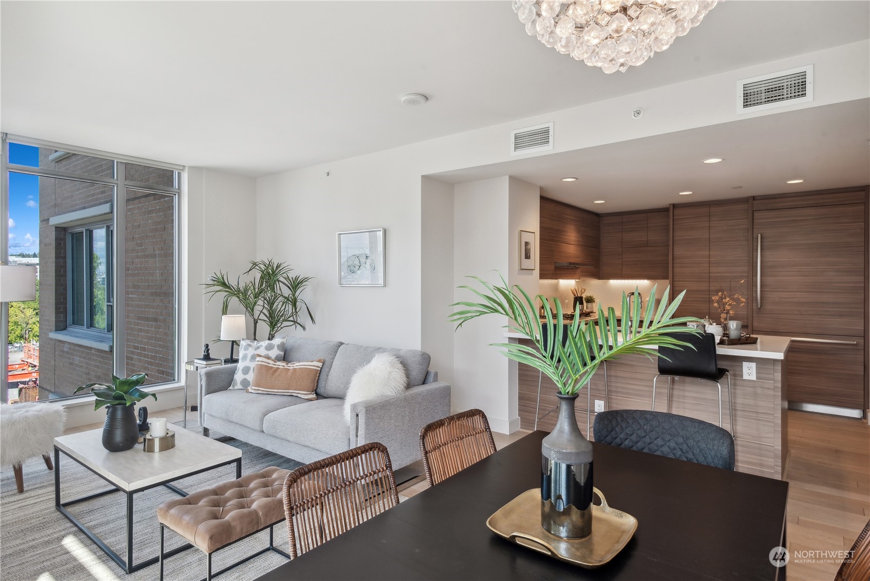 583 Battery Street, Unit 506N Seattle, WA 98121 - Photo 5 of 36 a living room with furniture potted plant and a window