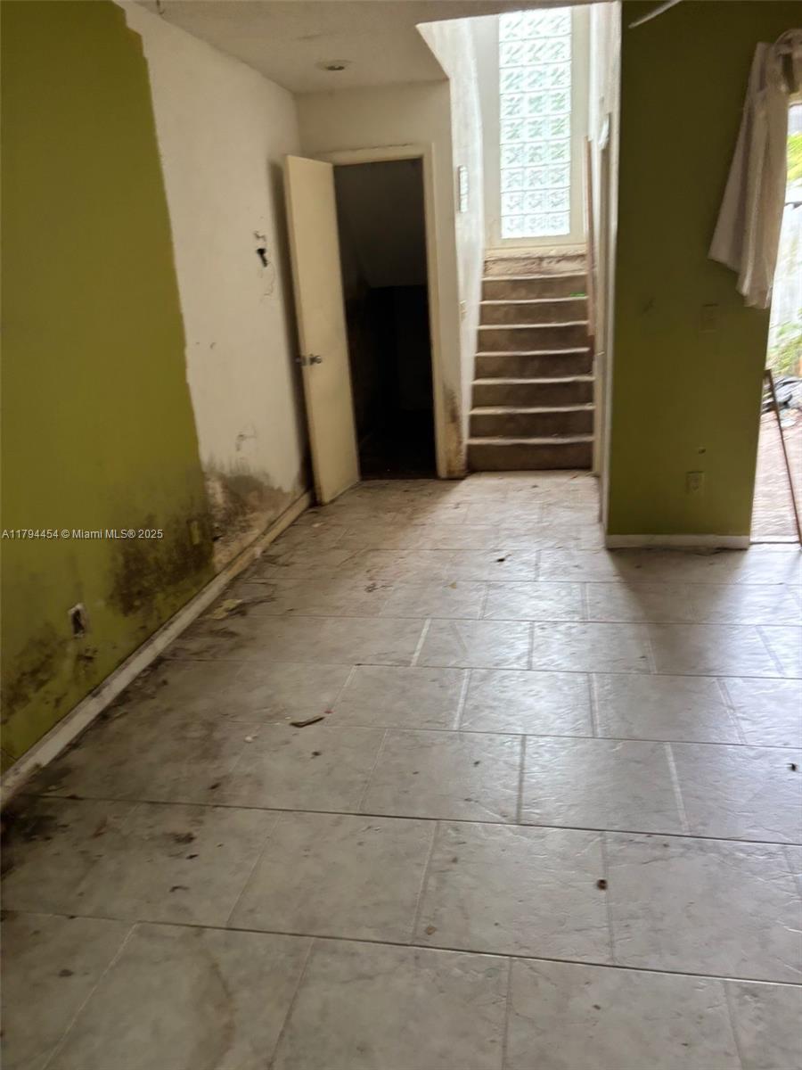 5040 Elmhurst Road, Unit A West Palm Beach, FL 33417 - Photo 6 of 12 a view of a room with an empty space and a window