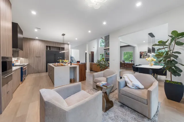 a kitchen with kitchen island granite countertop lots of counter top space and stainless steel appliances
