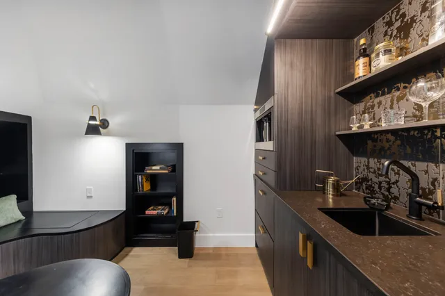 a bedroom with a bed a mirror and lamp