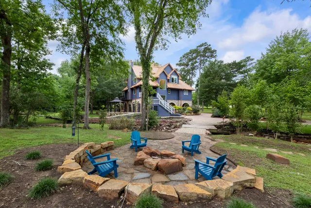 a front view of a house with garden and chairs