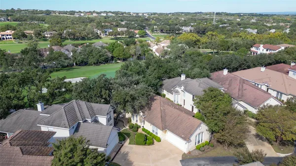 an aerial view of a house with pool outdoor space and lake view