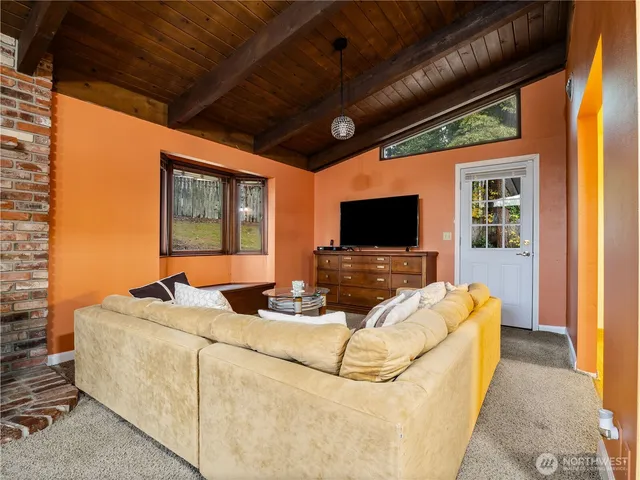a living room with furniture tv and a flat screen tv