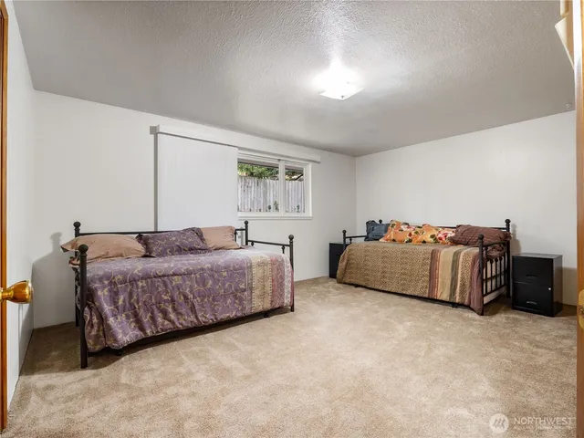 a bedroom with a bed and a couch