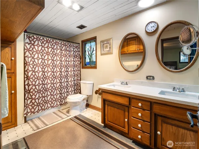 a bathroom with a sink mirror and vanity