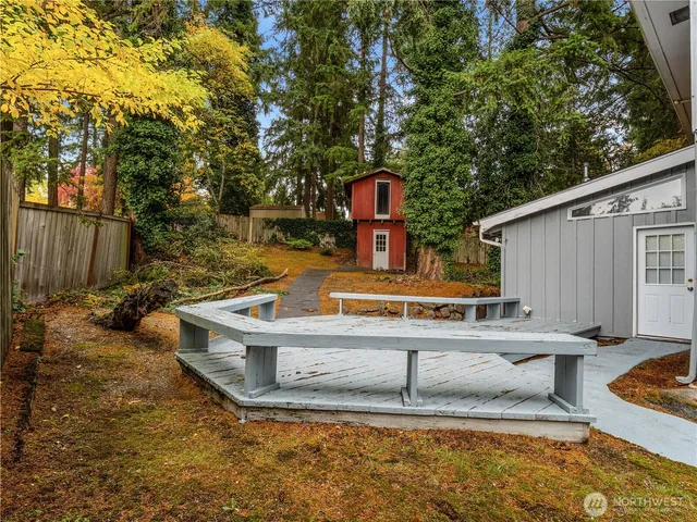 a view of a house with backyard and sitting area