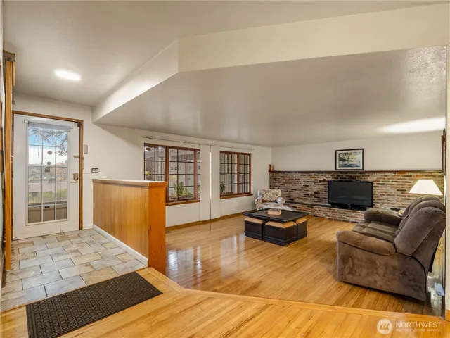 a living room with furniture window and wooden floor