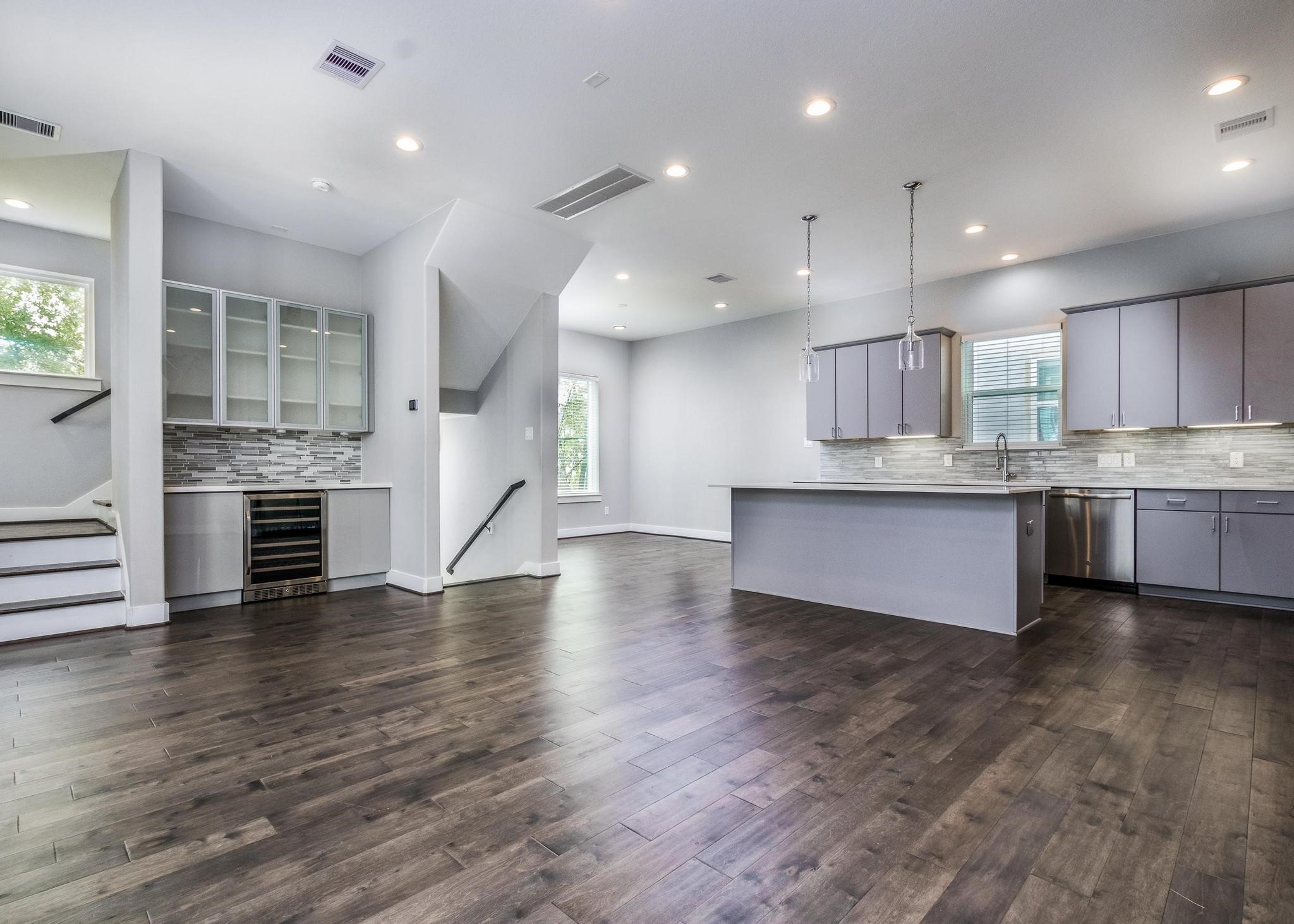 a large kitchen with stainless steel appliances granite countertop a large counter top a sink and a stove