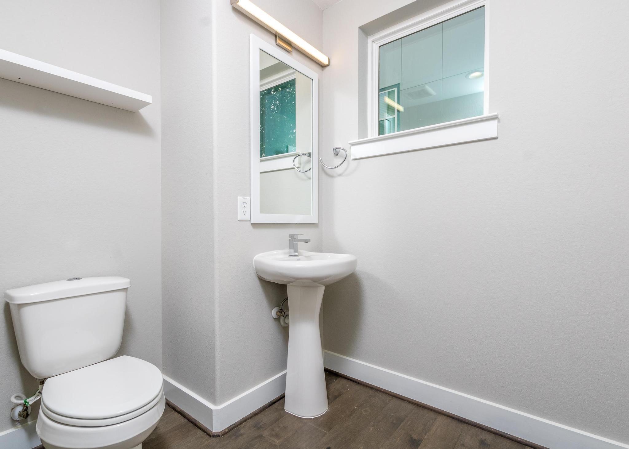 8409 Hempstead Road, Unit F Houston, TX 77008 - Photo 15 of 23 a bathroom with a toilet sink and mirror