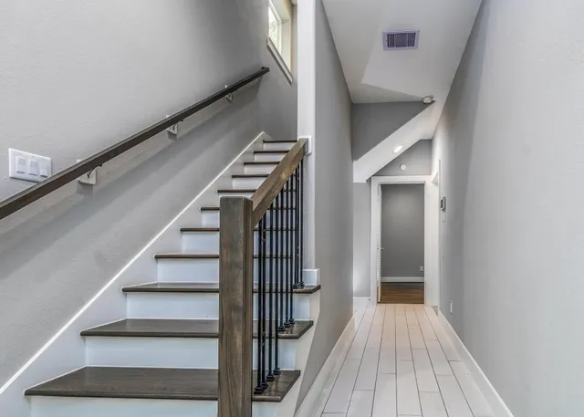 a view of entryway and hall with wooden floor