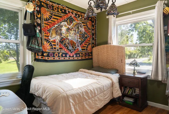 a bed sitting in a bedroom next to a window