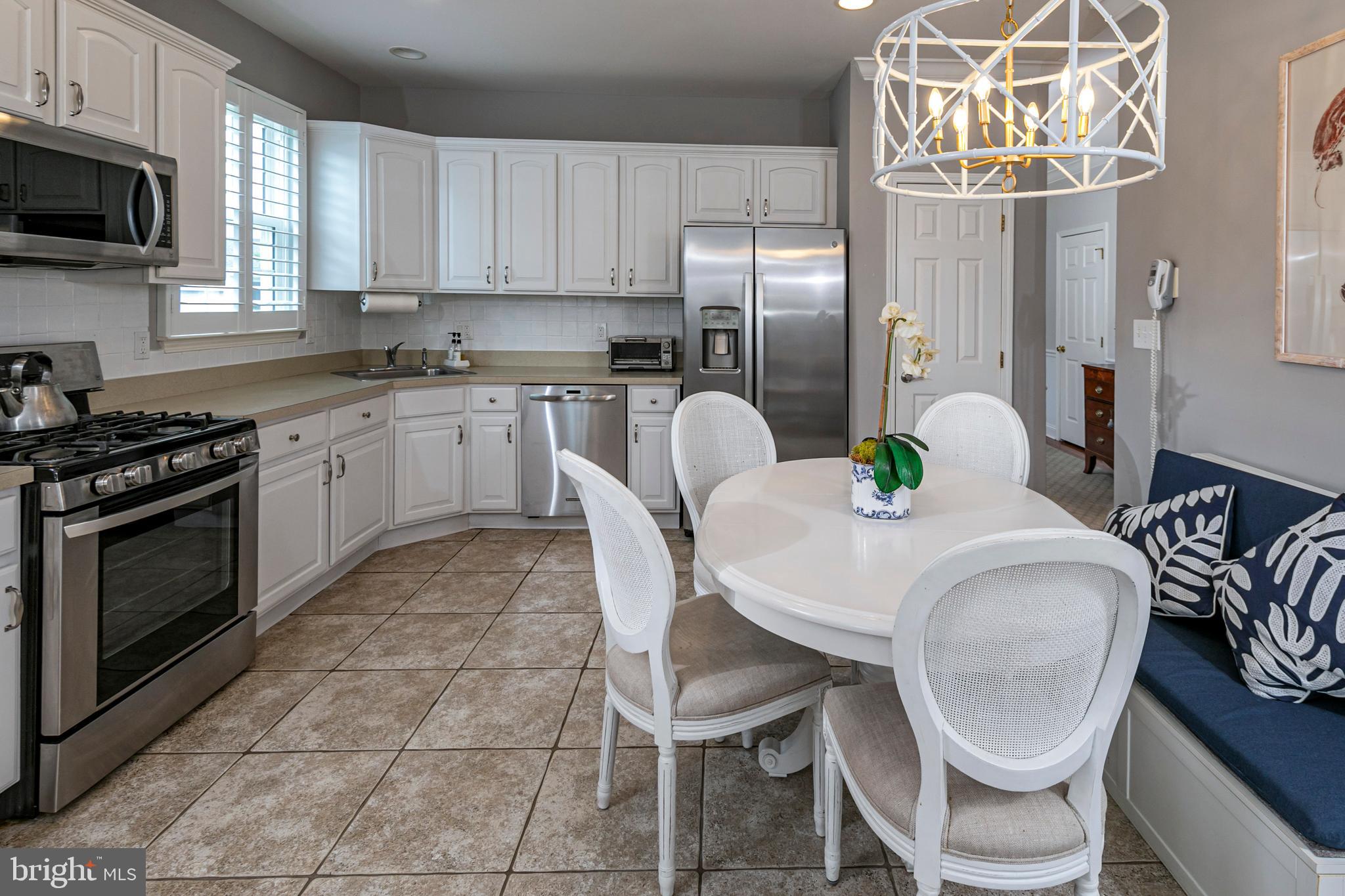 24 Foster Road Pennington, NJ 08534 - Photo 12 of 38 a kitchen with stainless steel appliances granite countertop a table chairs stove microwave and cabinets