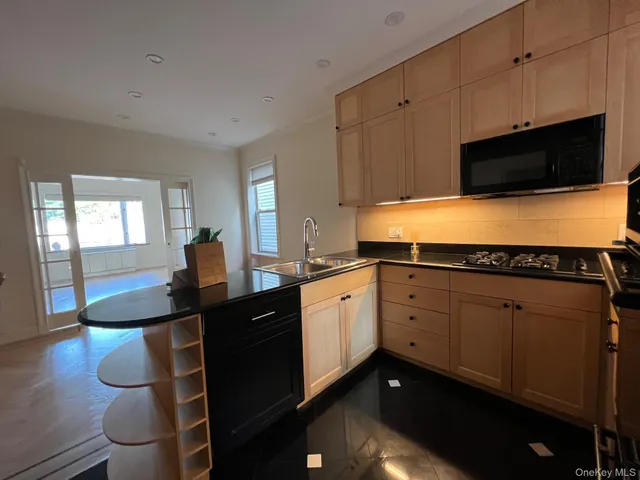 a kitchen with sink cabinets and microwave
