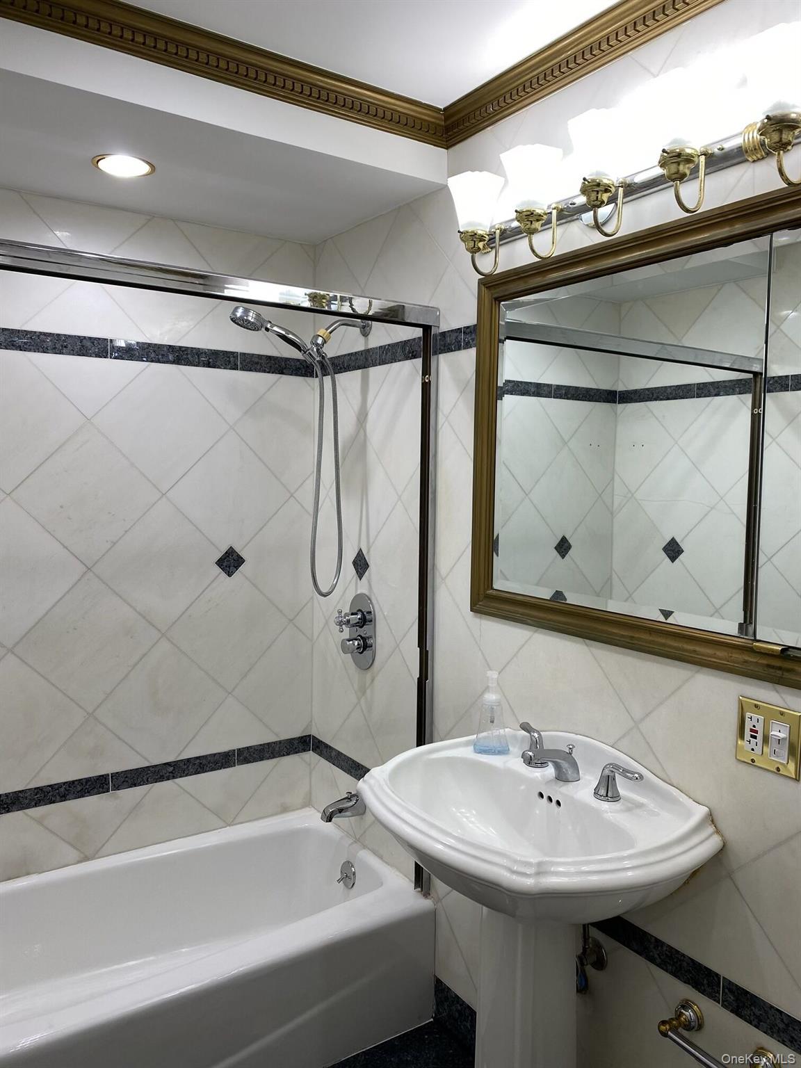 52-62 68th Street Queens, NY 11378 - Photo 10 of 15 a bathroom with a sink and a mirror