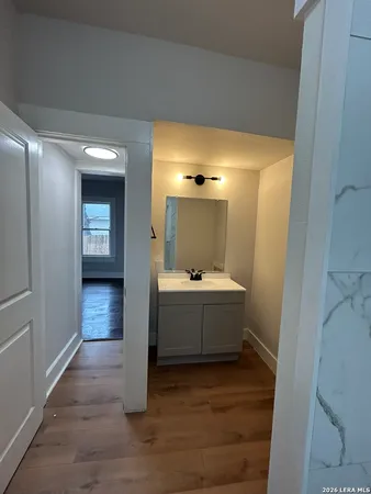 a view of bathroom with bathtub and wooden floor