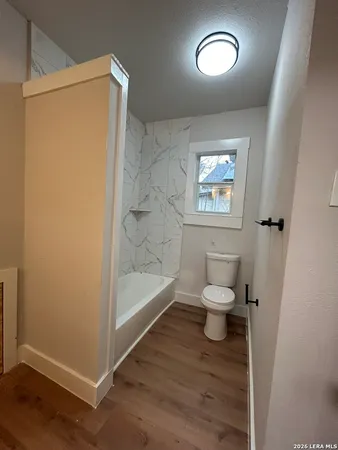 a bathroom with a toilet and a shower