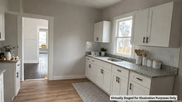 a kitchen with cabinets appliances and a window