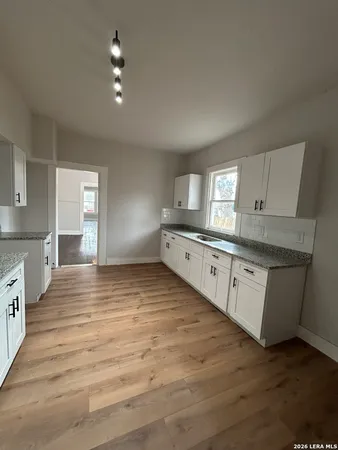 a large kitchen with kitchen island a sink stainless steel appliances and cabinets