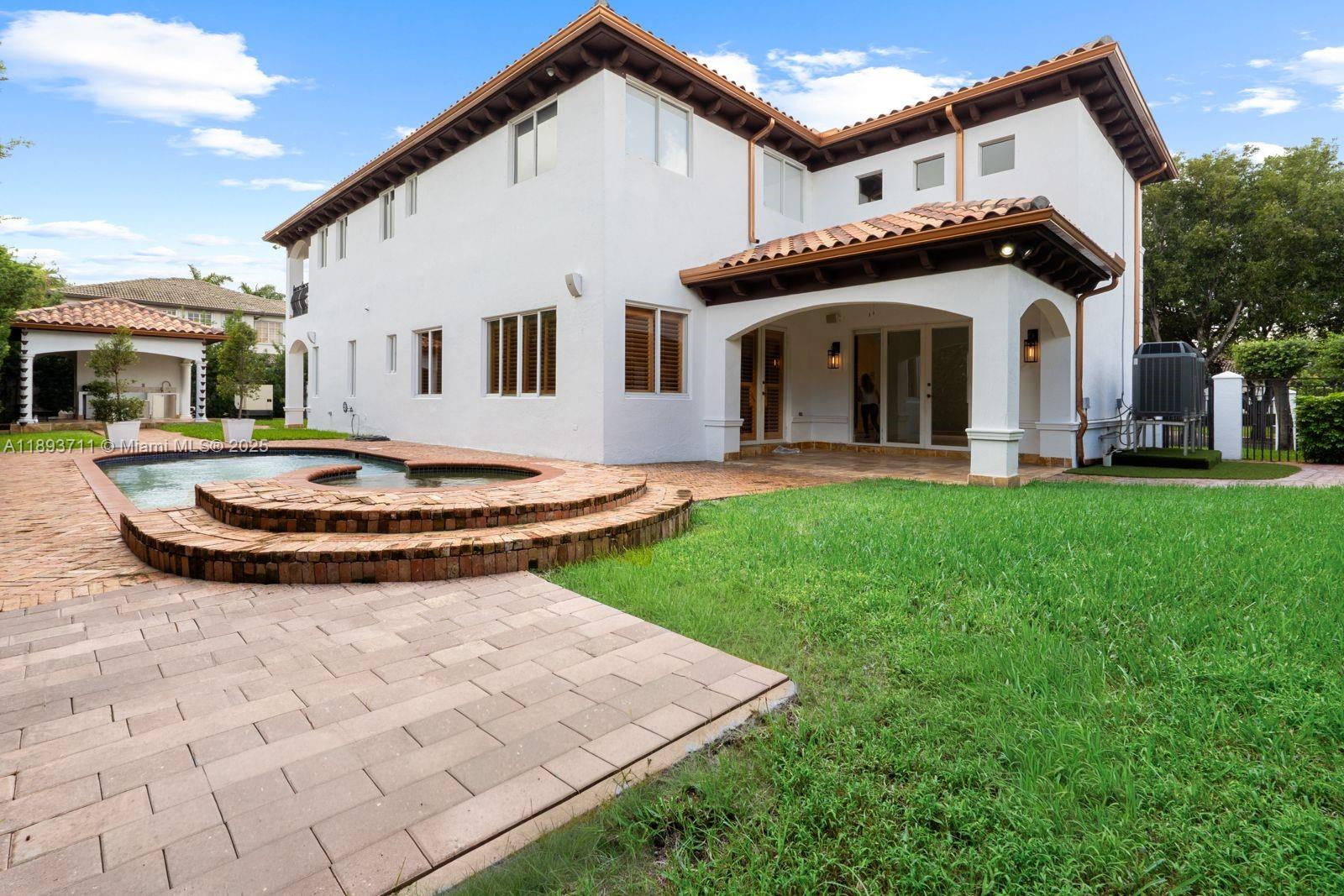 16763 Northwest 77th Path Miami Lakes, FL 33016 - Photo 12 of 53 a front view of a house with a garden and plants