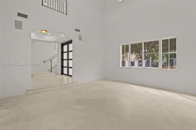 a view of an empty room with a large window and an outdoor view