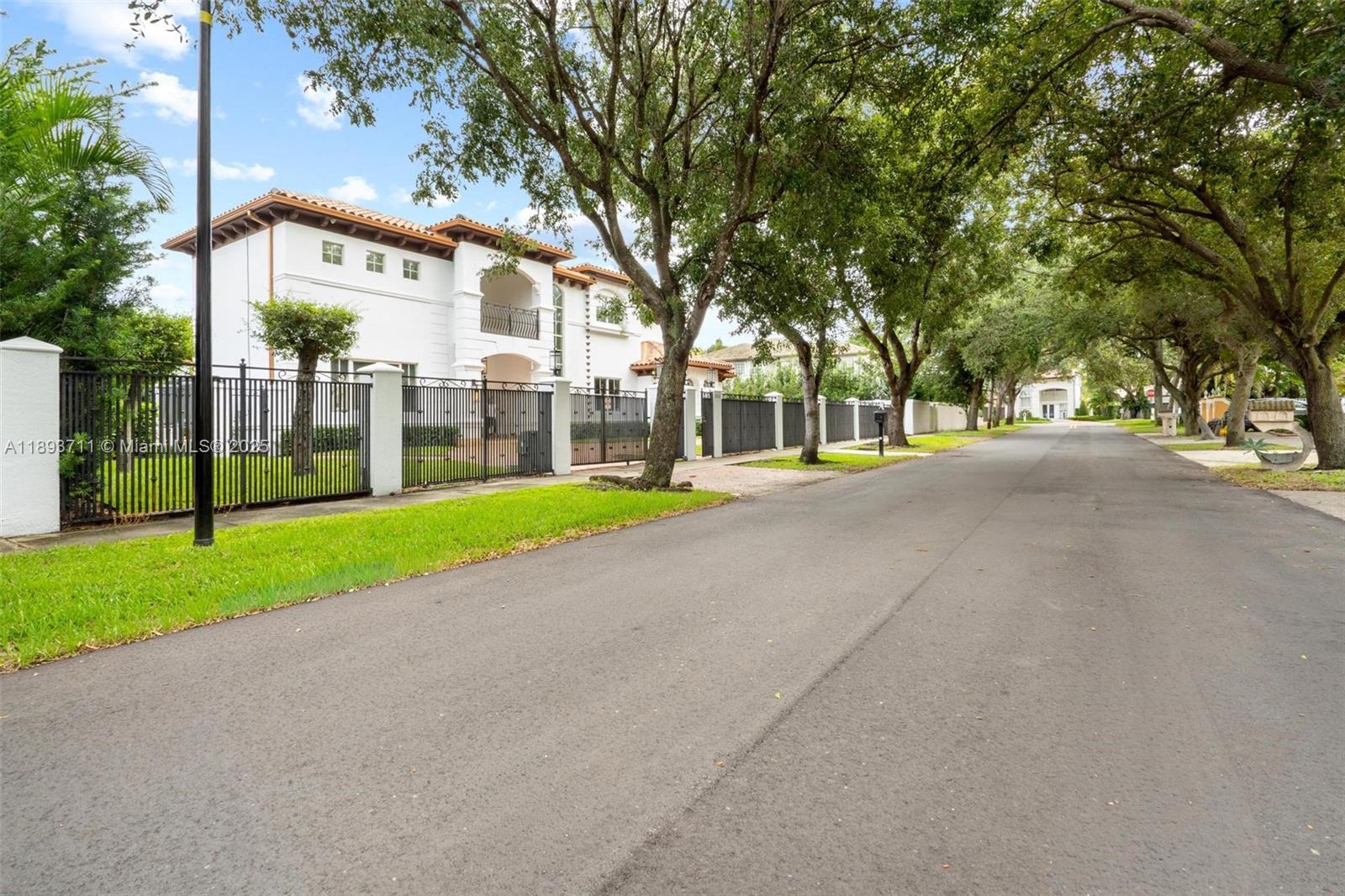 16763 Northwest 77th Path Miami Lakes, FL 33016 - Photo 2 of 53 a view of a house with a big yard and large trees
