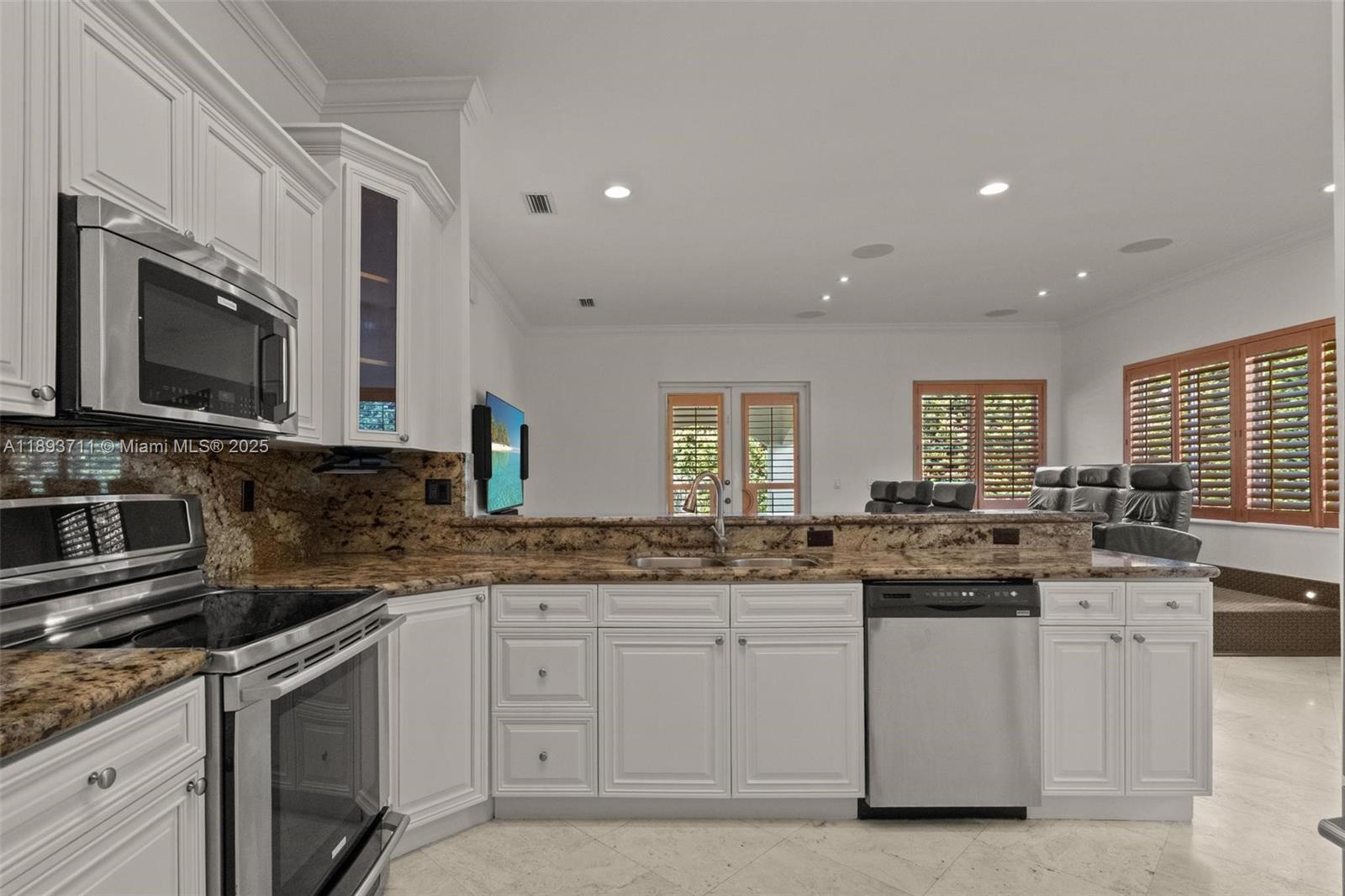 16763 Northwest 77th Path Miami Lakes, FL 33016 - Photo 24 of 53 a kitchen with stainless steel appliances granite countertop a sink stove and microwave