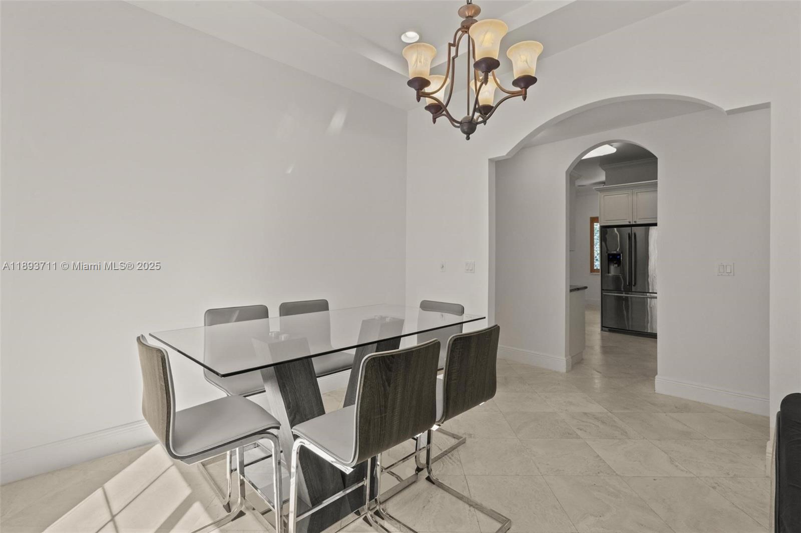 16763 Northwest 77th Path Miami Lakes, FL 33016 - Photo 27 of 53 a view of a hallway with chandelier