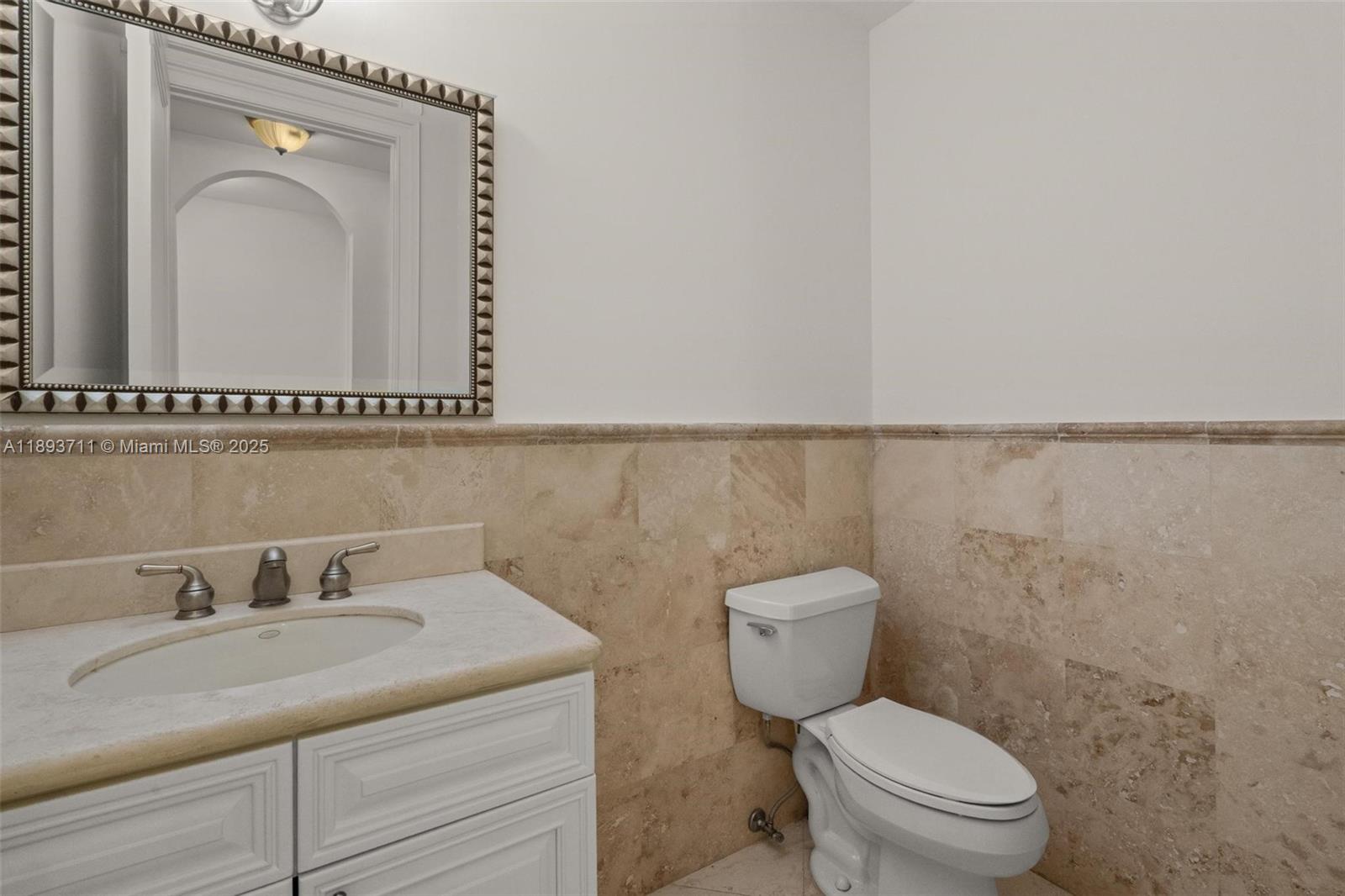 16763 Northwest 77th Path Miami Lakes, FL 33016 - Photo 28 of 53 a bathroom with a granite countertop sink mirror and toilet